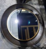 Modern circular wall mirror in a brushed steel cir