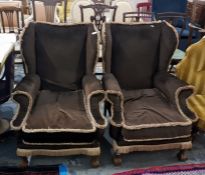 Pair of upholstered wingside easy chairs on squat