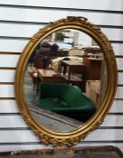 Oval wall mirror with gilt frame, ribbon decoratio