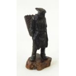 Bronzed figure of a man carrying wicker basket, st