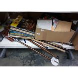 Collection of walking sticks, umbrellas, shooting