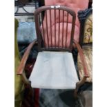 Stained wood framed spindle back open arm chair