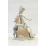 Lladro figure of young boy in pink dungarees with floral encrusted wheelbarrow and Lladro figure