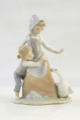 Lladro figure of young boy in pink dungarees with floral encrusted wheelbarrow and Lladro figure