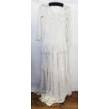 Cream lace vintage style eveing dress with frills, three-quarter sleeves and a cream lace halterneck