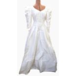 Late 1980's wedding dress with drop waist, embroidered bodice, leg o mutton sleeves, full skirt, bow