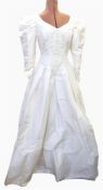 Late 1980's wedding dress with drop waist, embroidered bodice, leg o mutton sleeves, full skirt, bow