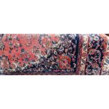 Large Persian style carpet with pink ground, scroll and foliate central medallion, allover floral