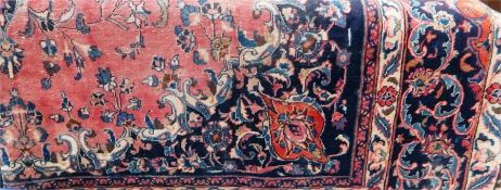 Large Persian style carpet with pink ground, scroll and foliate central medallion, allover floral