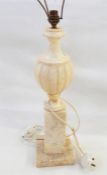 Alabaster table lamp, baluster shaped with gadrooned body, on tall square plinth and eight small