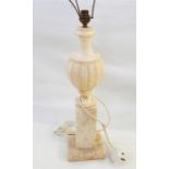 Alabaster table lamp, baluster shaped with gadrooned body, on tall square plinth and eight small