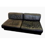Pair of De Sede Swiss leather chair beds, each in black leather, folding out to form single bed,