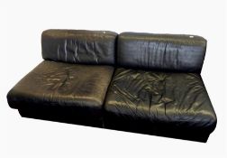 Pair of De Sede Swiss leather chair beds, each in black leather, folding out to form single bed,