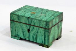 Malachite covered jewel box, the interior with brass fittings and pink ruched satin lining, on