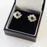 Pair emerald and diamond cluster earrings, each set centre circular facet-cut emerald having