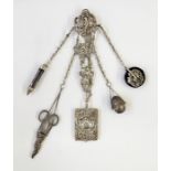 Victorian silver chatelaine of rococo style design, with pierced scrolls and cherubs, suspended with