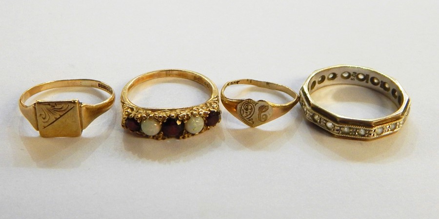 9ct gold, opal and garnet five-stone dress ring, two 9ct gold signet rings and a 9ct gold eternity
