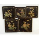 Set of five Japanese graduated lacquer small trays, square, each decorated with exotic bird on