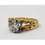 18ct gold solitaire diamond ring, the diamond in white gold illusion setting, pierced scroll