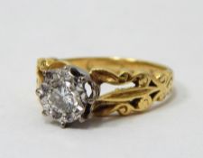 18ct gold solitaire diamond ring, the diamond in white gold illusion setting, pierced scroll