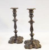 Pair of early 20th century silver baluster-shaped candlesticks of shaped square design with shell