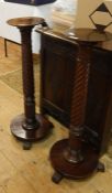 Pair of early 19th century-style mahogany torcheres with stiff leaf carved terminals to the spirally