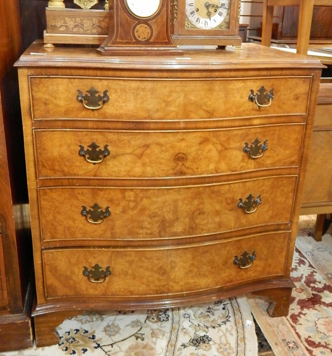 Reproduction figured walnut serpentine-front chest of four long drawers with brass drop handles