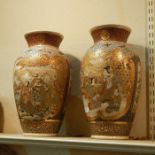 Pair of 19th century Japanese satsuma earthenware vases, each with shaped panels, variously of a