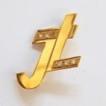 18ct gold brooch in the form of "JL" set with six chip diamonds, 4.9g