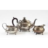 Silver three-piece teaset of shaped rectangular form with bead border, on four hoof feet, Birmingham