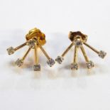Pair of gold and diamond earrings, a central diamond with four diamond drops