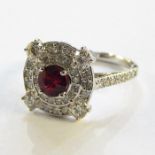 18K white gold, ruby and diamond cluster ring set centre circular facet-cut Burmese ruby with
