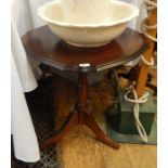 Reproduction mahogany occasional table, circular with serpentine edge, on turned column tripod base,