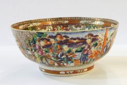 Chinese porcelain punch bowl in famille rose colours, decorated with figures on a lakeside