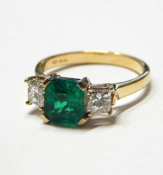 18K gold, emerald and diamond ring set centre cushion-cut emerald, 6.5mm square flanked by pair
