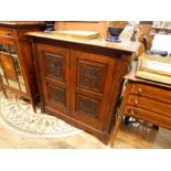 Carved oak side cabinet, having fluted fore-pillasters, bi-fold framed panelled door with foliate