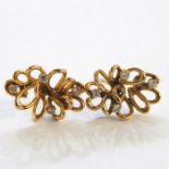 Pair of gold and diamond flower-shaped earrings (unmarked), 4g in total approx