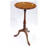 Stained wood tripod wine table having scallop carved edge, on baluster column, three scroll