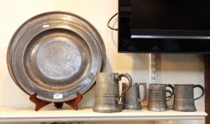 Five various 19th century pewter tankards, possibly earlier and two large pewter platters,142cm