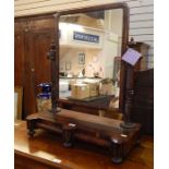 Early Victorian mahogany toilet mirror, the rectangular plate on spirally reeded and foliate