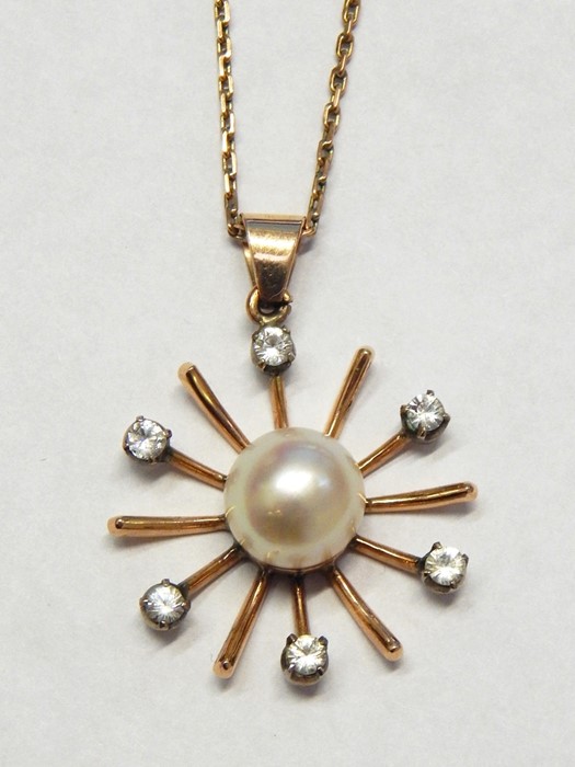 14ct rose gold star-shaped pendant on chain with central cultured pearl surrounded by six