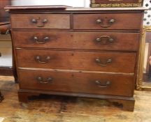 Oak chest of two short and three long drawers with brass swing handles, on bracket feet, 109cm