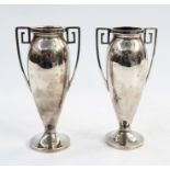 Pair of early 20th century silver vases with Greek key handles, ovoid bodies to circular feet,