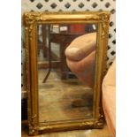 Gilt wall mirror, rectangular with floral scroll and shell borders, 72cm x 46cm approx