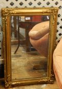 Gilt wall mirror, rectangular with floral scroll and shell borders, 72cm x 46cm approx