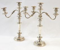 Pair of EPNS table candelabra, each three-light with pair reflex scroll branches, on tapering