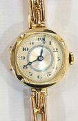 Lady's 9ct gold wristwatch with circular engine-turned dial, button winding and the expanding strap