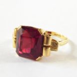 Late 19th/early 20th century 18ct gold and red stone dress ring, the square faceted red stone in