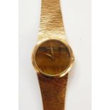 Lady's Beuche-Girod 9ct gold bracelet watch, the circular dial with circular tiger's eye quartz dial