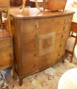 20th century polished wood bowfront chest of five graduated drawers with brass drop scroll handles